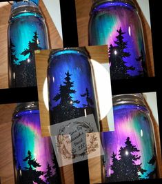 there is a jar with trees painted on it and the lights are blue, purple, and green