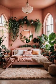 a bedroom with pink walls and lots of greenery on the wall, including plants