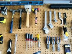 there are many tools on the peg board