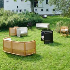 several chairs and couches sitting in the grass