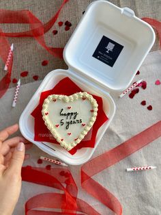 a heart shaped cake in a box on a table