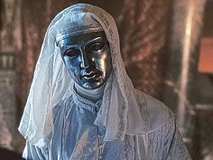 a close up of a statue of a person wearing a veil