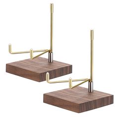 two brass - plated metal and wood bookends on wooden bases, each holding books