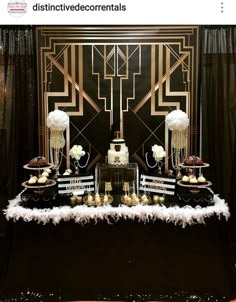 a black and gold dessert table with white flowers