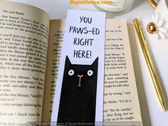 an open book with a black cat on it and the words you paws - ed right here