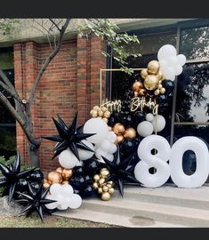 balloons and streamers decorate the front steps of a home for an 80th birthday party