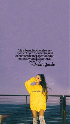 a woman standing on top of a pier next to the ocean with a quote above her