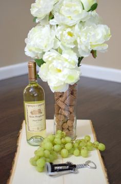 a bottle of wine and some grapes on a tray