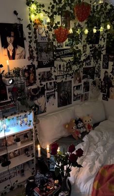 a bed room with a neatly made bed and lots of pictures on the wall