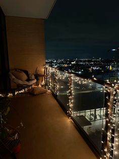 a balcony covered in christmas lights overlooking the city