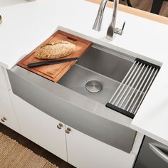 a kitchen sink with a cutting board and knife