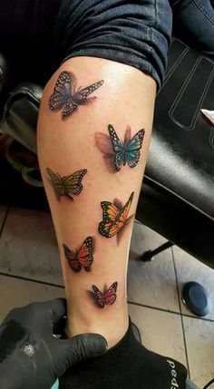 a woman's leg with butterflies on it