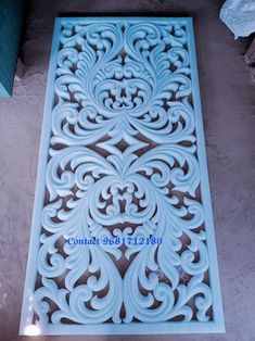 an ornate design on the side of a wall in blue and white colors, is shown