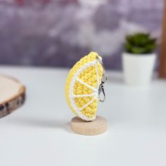 a lemon keychain is sitting on a table