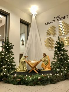 the nativity scene is decorated with christmas trees