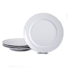 three white plates stacked on top of each other in front of a white background,