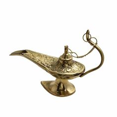 an antique brass oil lamp on a white background