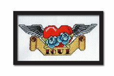 a cross stitched picture with the words love and flowers on it, in black frame