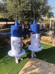 two inflatable blue and white figures standing on grass