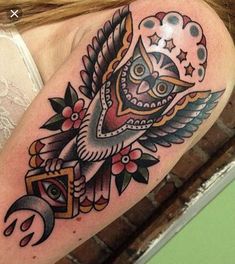 a woman's arm with an owl and star tattoo on the left side of her body