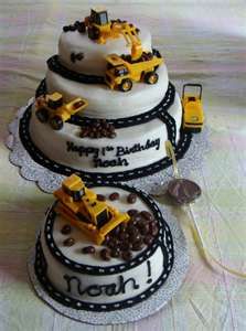 two birthday cakes with construction vehicles on them