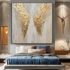 a large painting hanging on the wall above a bed