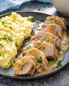 meatloaf with gravy and mashed potatoes on a plate