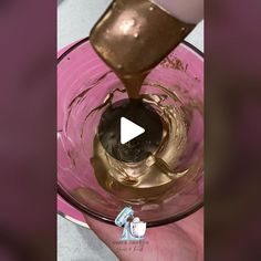 someone is pouring chocolate into a blender to make it look like they are making something