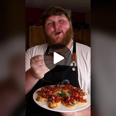 a man is holding a plate with small appetizers on it and making a funny face