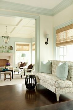 a living room filled with furniture and a fire place in the middle of a room