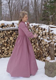 The gently fitted bodice of this Victorian styled work dress has a high collar, and three-quarter sleeves with buttoned cuffs.The full three-gored skirt is gathered smoothly into the bodice at the waist, and includes very practical pockets. Buttons close the front for easy dressing. Machine or hand wash on gentle cycle in cold water; Tumble dry on low setting or hang to dry. Proudly made by Recollections in America. Liesa is also wearing a crinoline, boots, and they are priced separately. The fo 1800s Dresses, Pioneer Clothing, Amish Living, Pioneer Dress, Farm Dress, Gored Skirt, Old Fashion Dresses, Easy Dressing, Work Dress