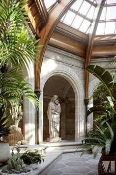 an indoor area with plants and statues in the center, surrounded by large arched windows