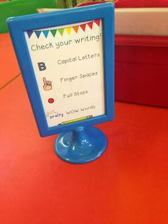 a blue sign sitting on top of a red table