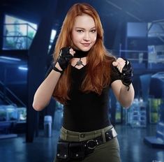 a woman with red hair wearing black gloves