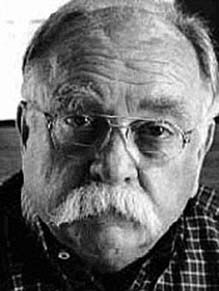 an old man with glasses and a mustache is posing for a black and white photo