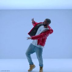 a man in a red jacket is dancing