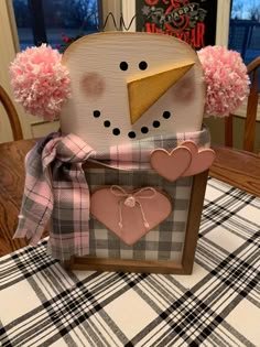 a close up of a snowman decoration on a table