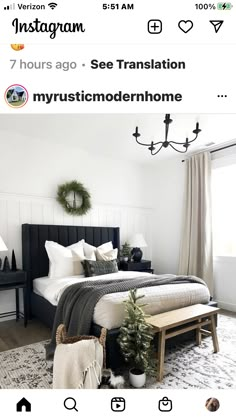 an instagramted photo of a bedroom with white walls and black furniture, including a bed