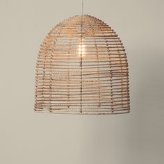 a light that is hanging from a ceiling with some kind of bamboo decoration on it