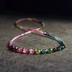 While it may not be a common practice, I especially choose to rearrange each of the tiny beads when creating this necklace. This allows for a gentle gradation of colors, creating a smooth transition between different shades of tourmaline and resulting in a beautiful and harmonious necklace. By taking the extra time and effort to carefully arrange the beads, I can create a unique and personalized piece that showcases the full range of colors found in tourmaline. 【Stone】 Multi-color Tourmaline 【Stone Size】 2.5mm 【Gold beads】 14K Solid gold 【Metal Component】 14K solid gold  【Necklace length】 16" 【Customers outside the U.S.】 International customers are subject to customs/duty fees from the post office upon delivery. Especially UK customers, please be aware. Tourmaline Gemstone Beaded Necklaces With Round Beads, Tourmaline Beaded Necklaces For Jewelry Making, Tourmaline Gemstone Beaded Necklaces, Tourmaline Gemstone Beaded Necklace, Tourmaline Single Strand Necklace With Round Beads, Multicolor Tourmaline Beaded Necklace With Faceted Beads, Multicolor Beaded Tourmaline Jewelry, Pink Tourmaline Beaded Necklaces, Pink Tourmaline Necklaces With Round Beads