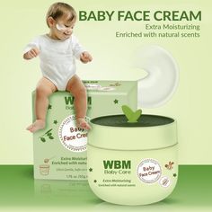 a baby sitting on top of a box of w b m baby face creams