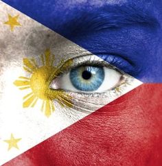 a woman's face painted in the colors of the philippines flag with blue eyes