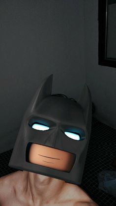 a man wearing a batman mask with glowing eyes