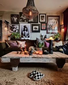 a living room filled with lots of furniture and pictures on the wall above it's coffee table