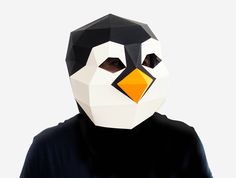 a person wearing a paper mask with a penguin face on it