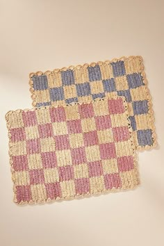 two pieces of woven rugs sitting next to each other