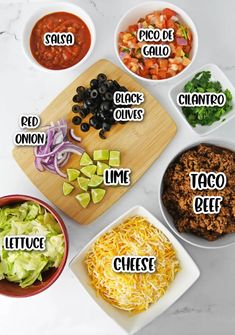 the ingredients for taco salad laid out on a cutting board with names in spanish