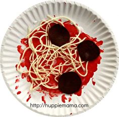 a white paper plate topped with red sauce and chocolate covered pastries on top of noodles