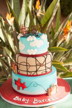 a three tiered cake with an airplane on top