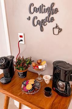 a wooden table topped with coffee cups next to a wall mounted sign that says cartitos cafe